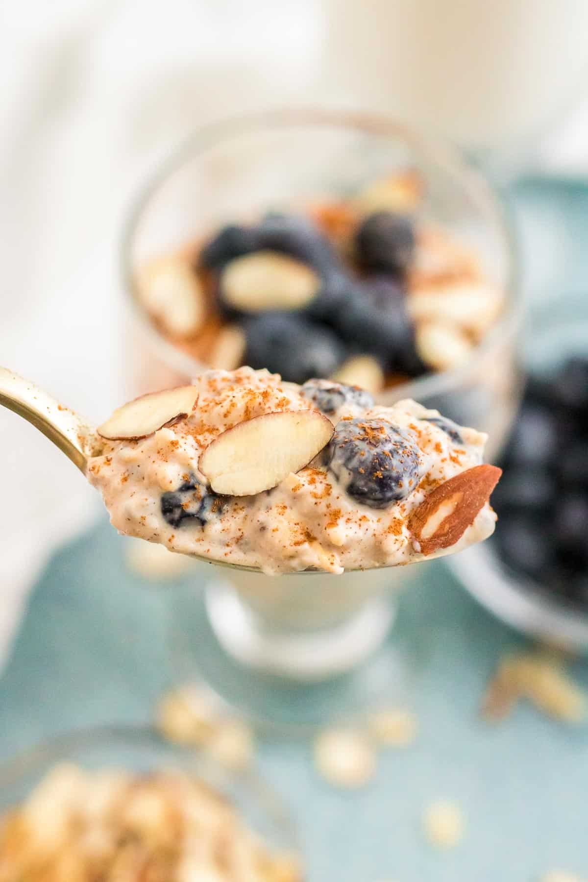 blueberry overnight oats in glasses spoonful.