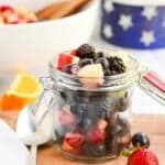 red white and blue fruit salad in jar.