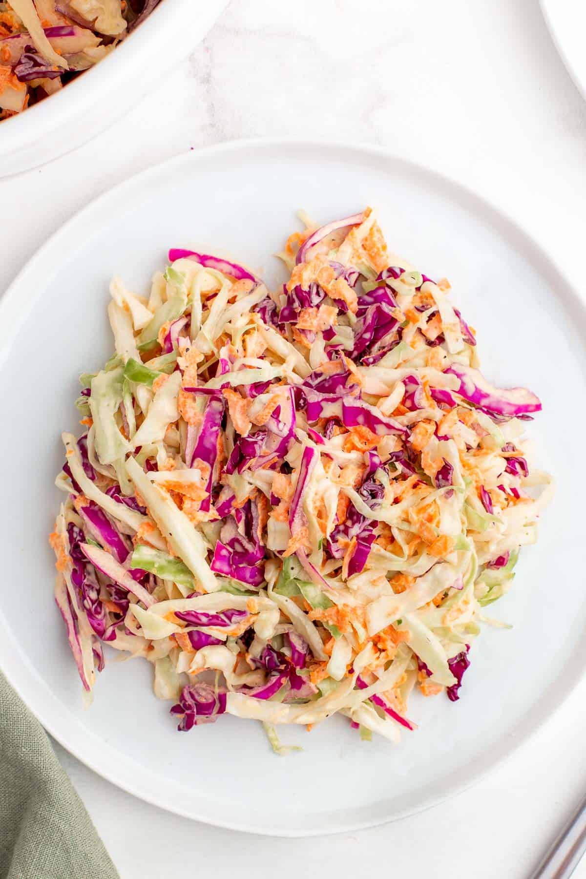 skinny coleslaw on a white plate.