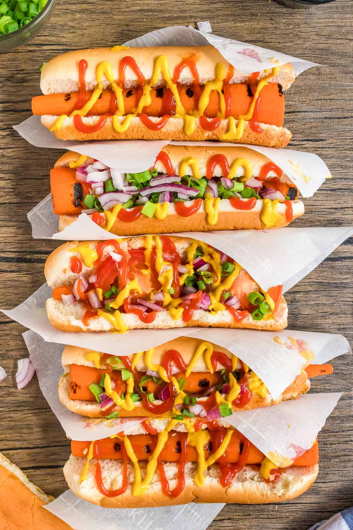 carrot dogs in buns in a line.