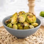 air fryer brussels sprouts in a bowl side cropped.