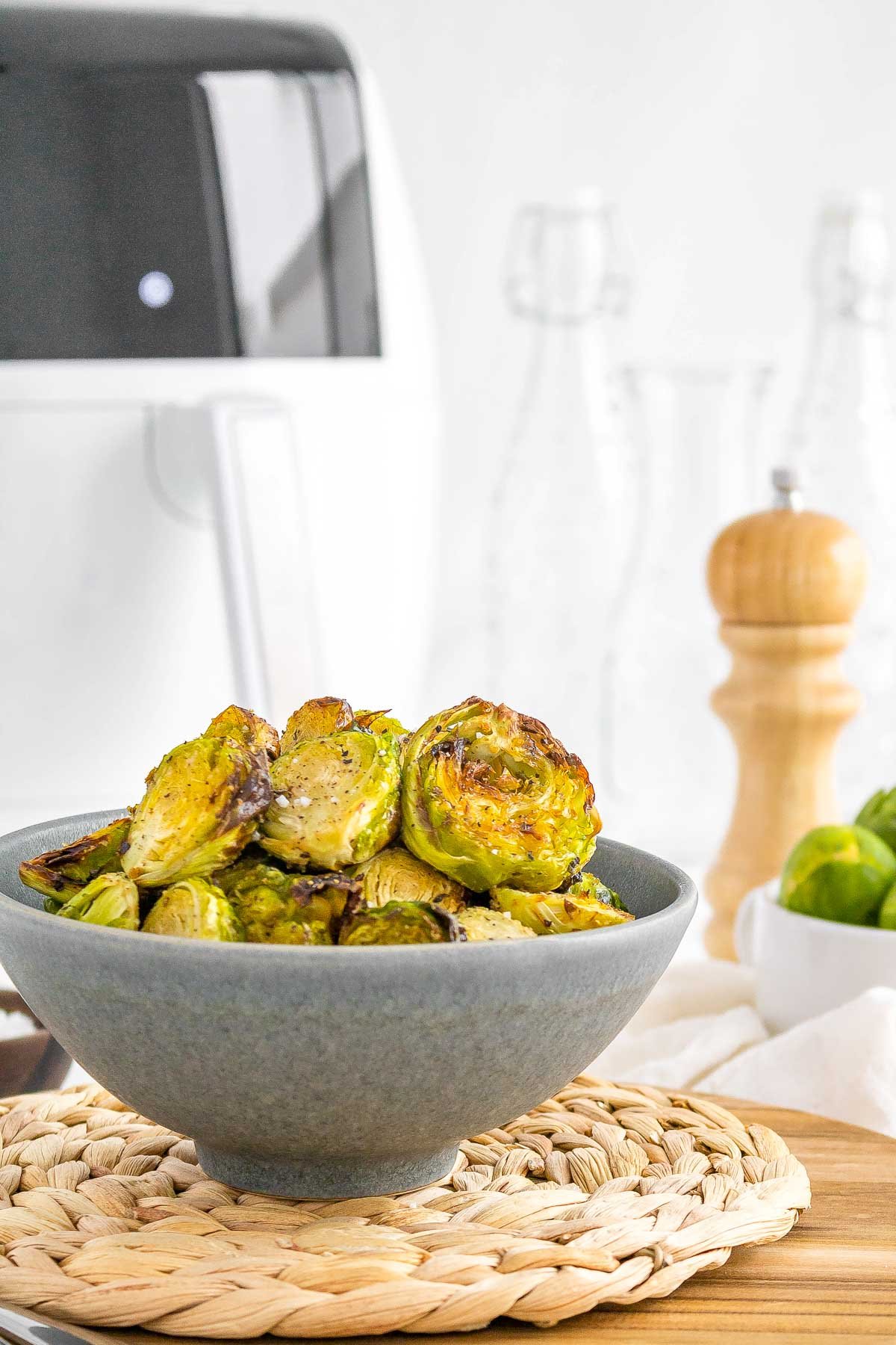 air fryer brussels sprouts in a bowl side view.