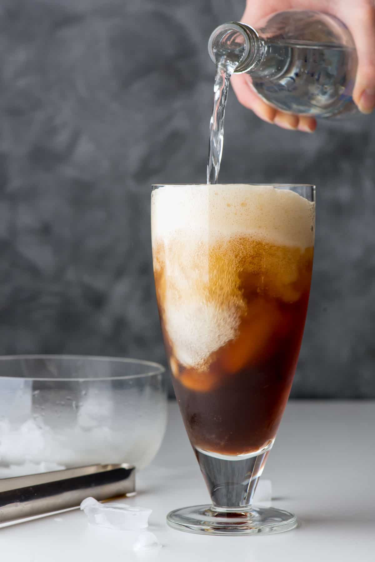 pouring club soda into coffee with ice.