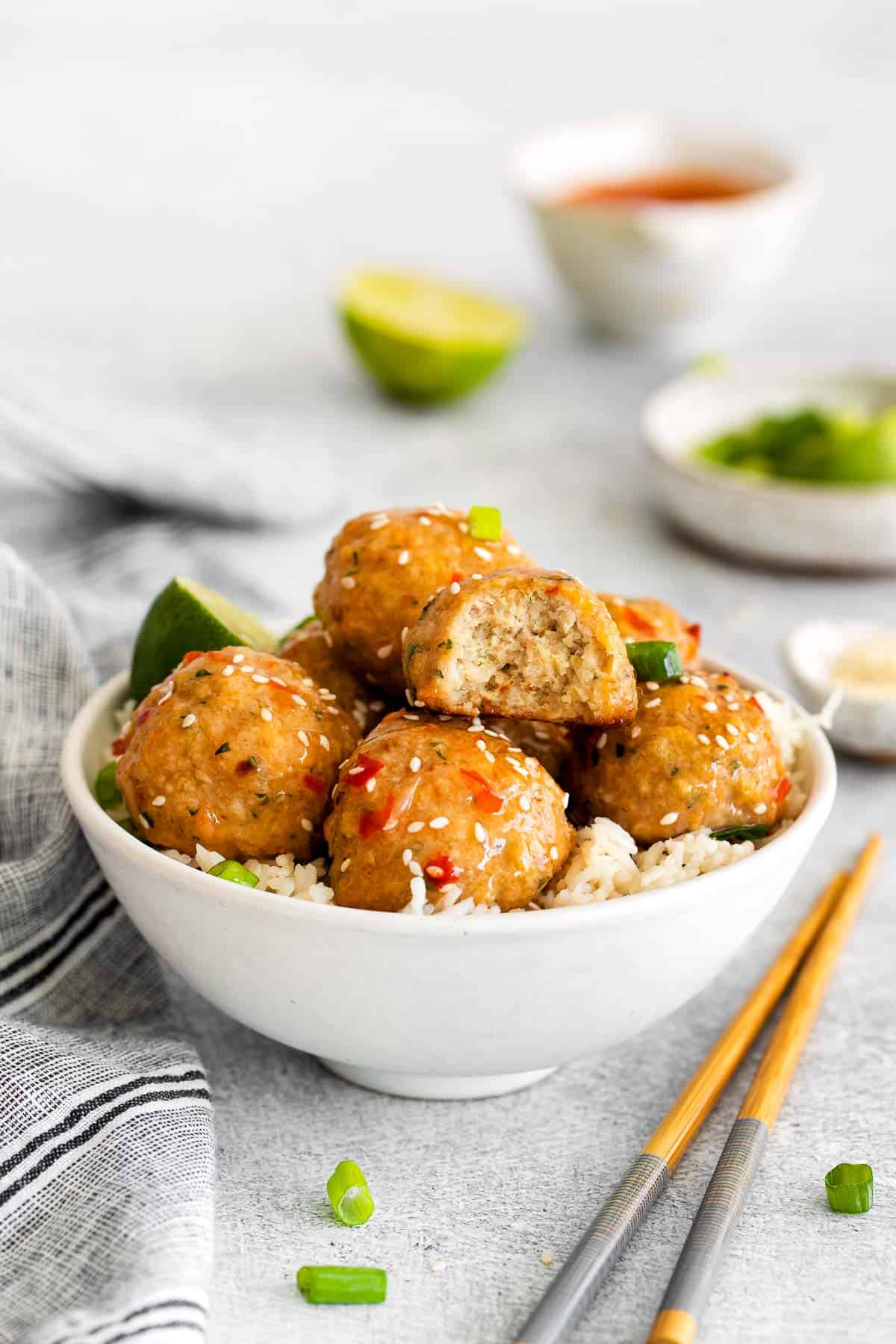 ground chicken meatballs in bowl side view with bite.