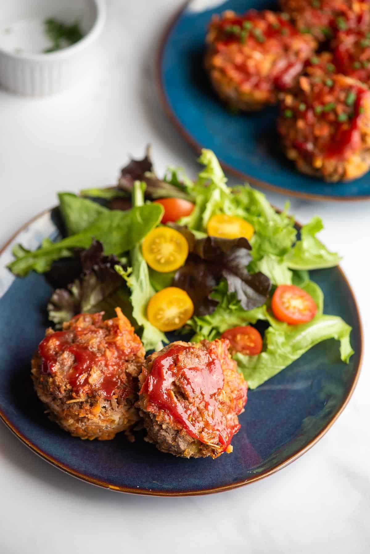 mini meatloaves on plate with salad