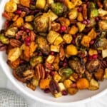 air fryer roast vegetables with pecans and pomegranate seeds.