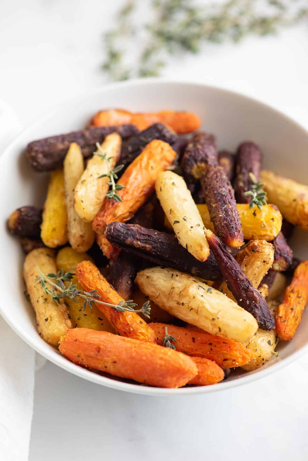 air fryer baby carrots cooked in a bowl close up.