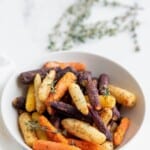 air fryer baby carrots with thyme sprigs.