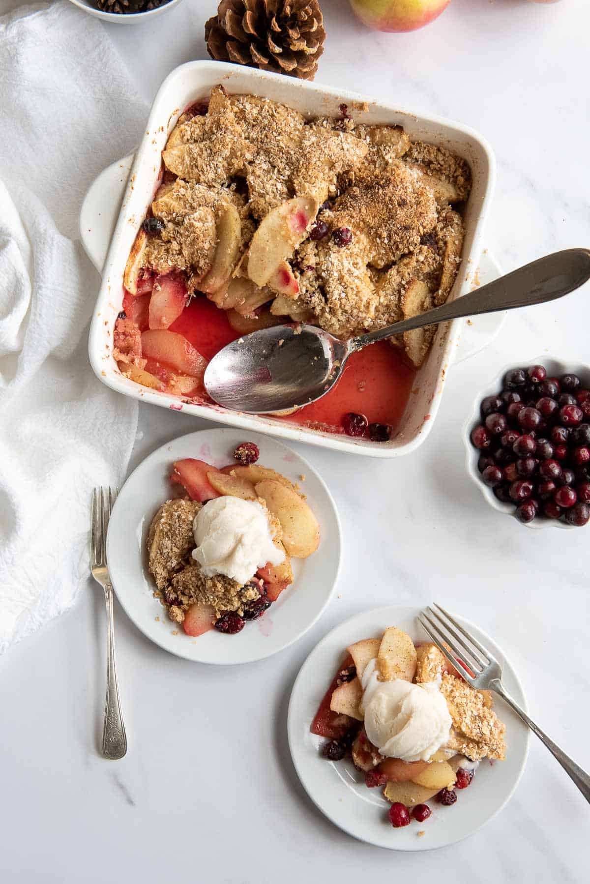 pple cranberry crisp in baking dish and servings.