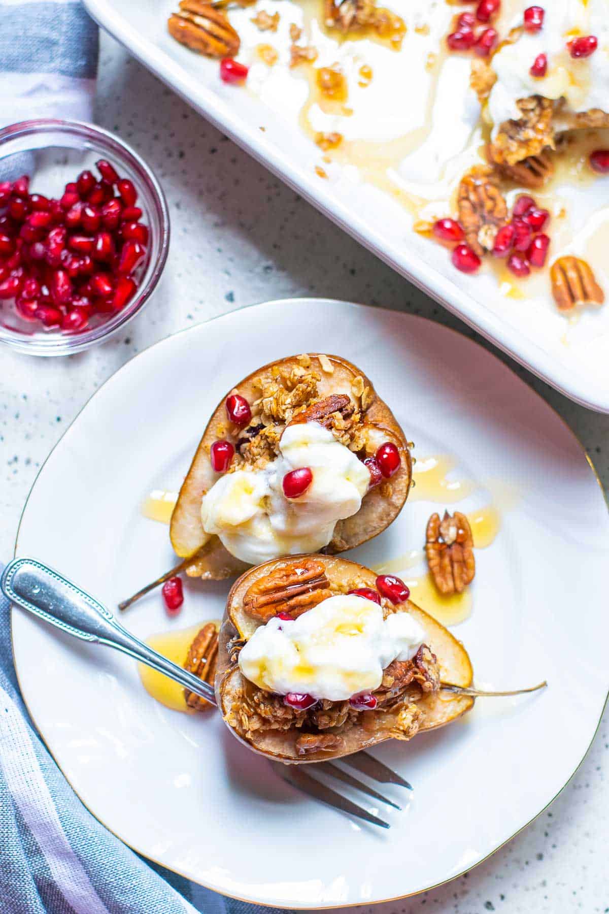 baked pears in a baking dish with toppings.