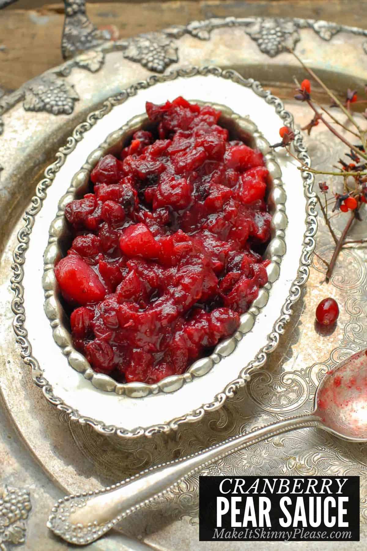 cranberry pear sauce in a silver serving bowl with spoon.