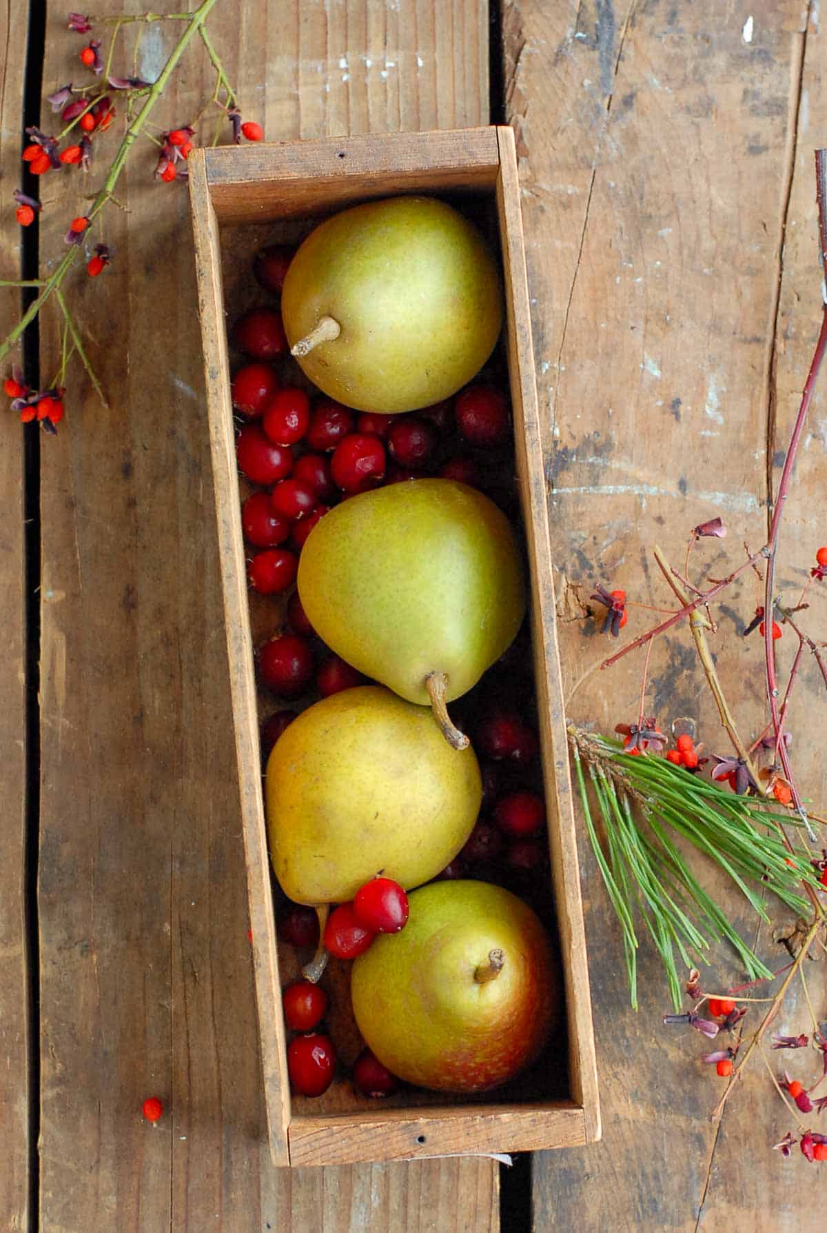 pears and cranberries in box.