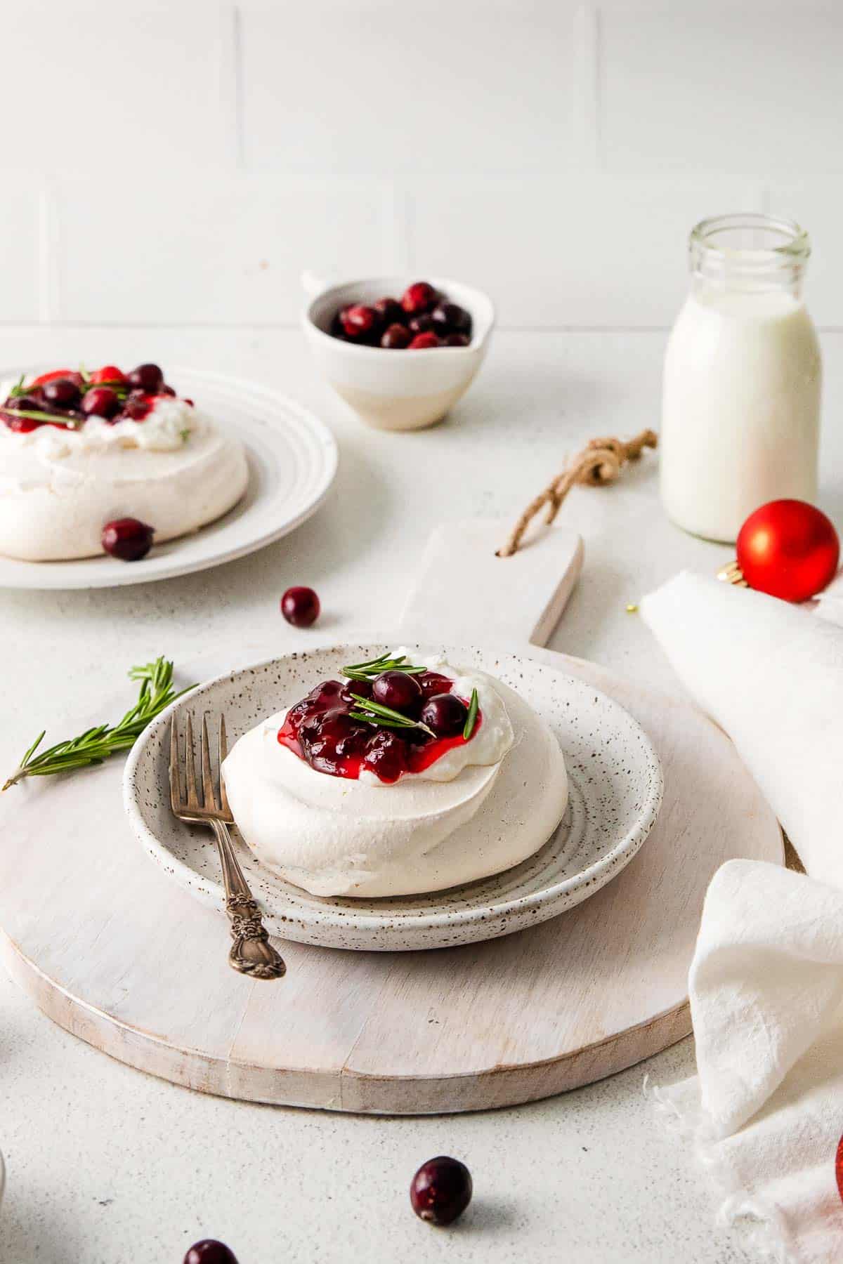 mini pavlovas on plate with cranberry compote.