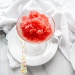 pink champagne granita in glass with spoon.