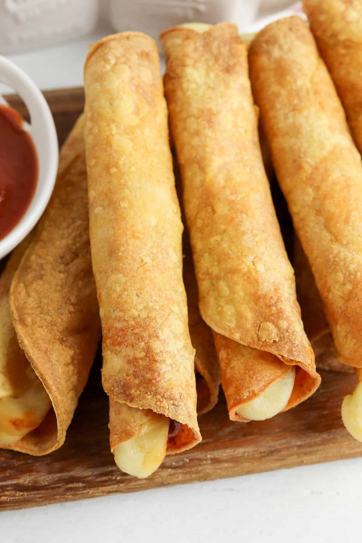 air fryer pizza roll ups with dipping sauce close up.