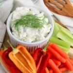 cream cheese dill dip with cut raw vegetables.
