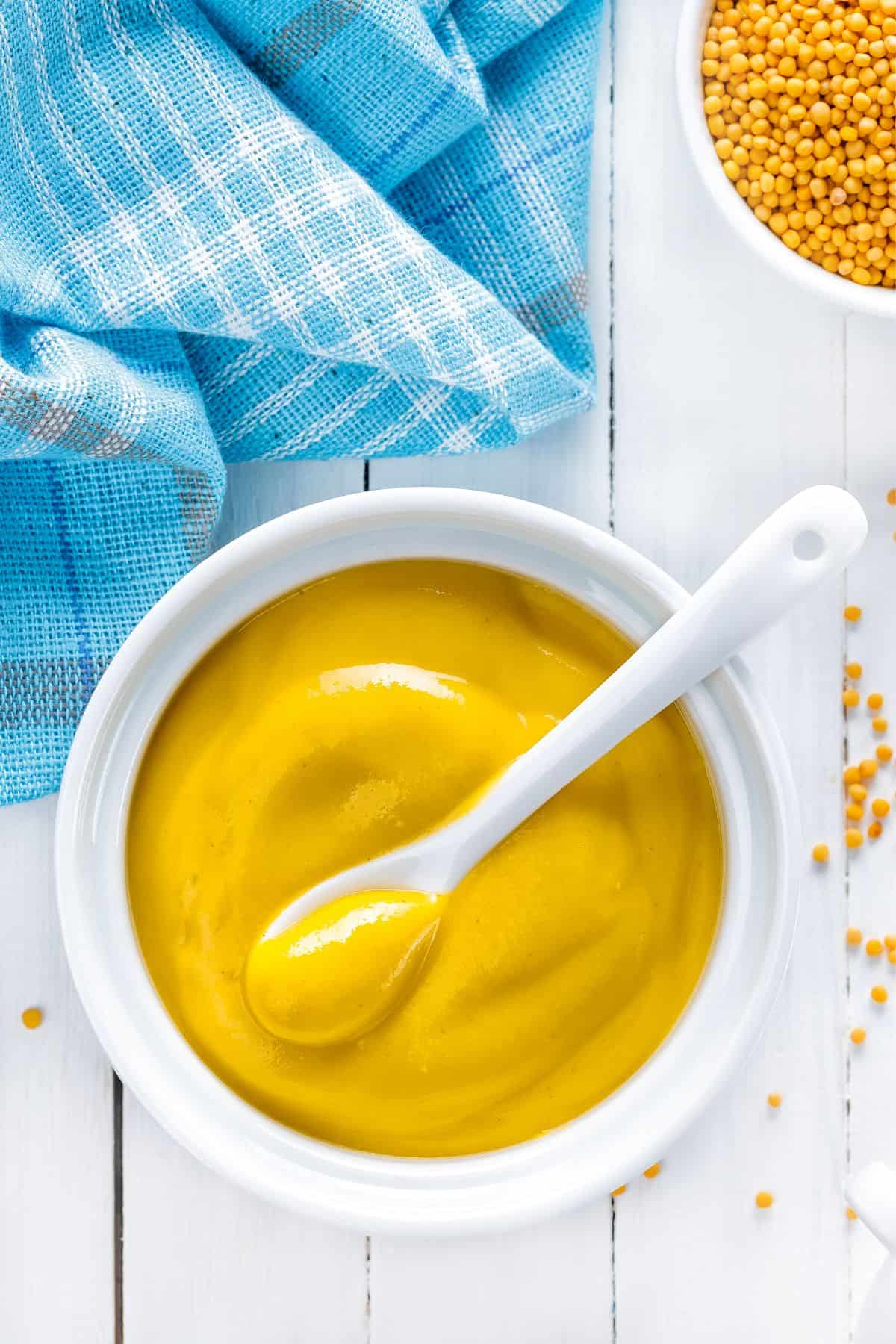 yellow mustard in a white bowl