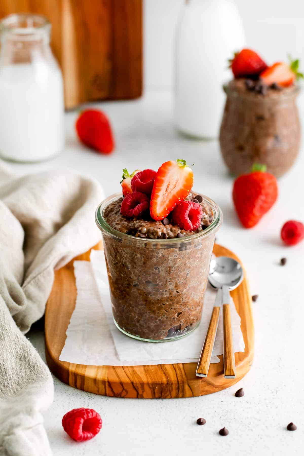 chocolate chia pudding in jar with berries.