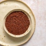 ancho chile powder in off white bowl.