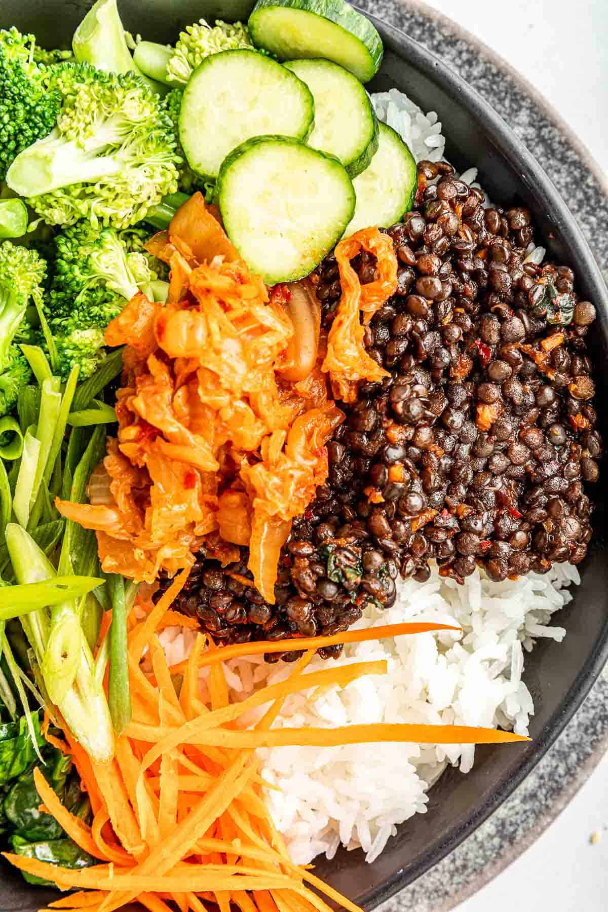 buddha bowl recipe with kimchi from above close up.