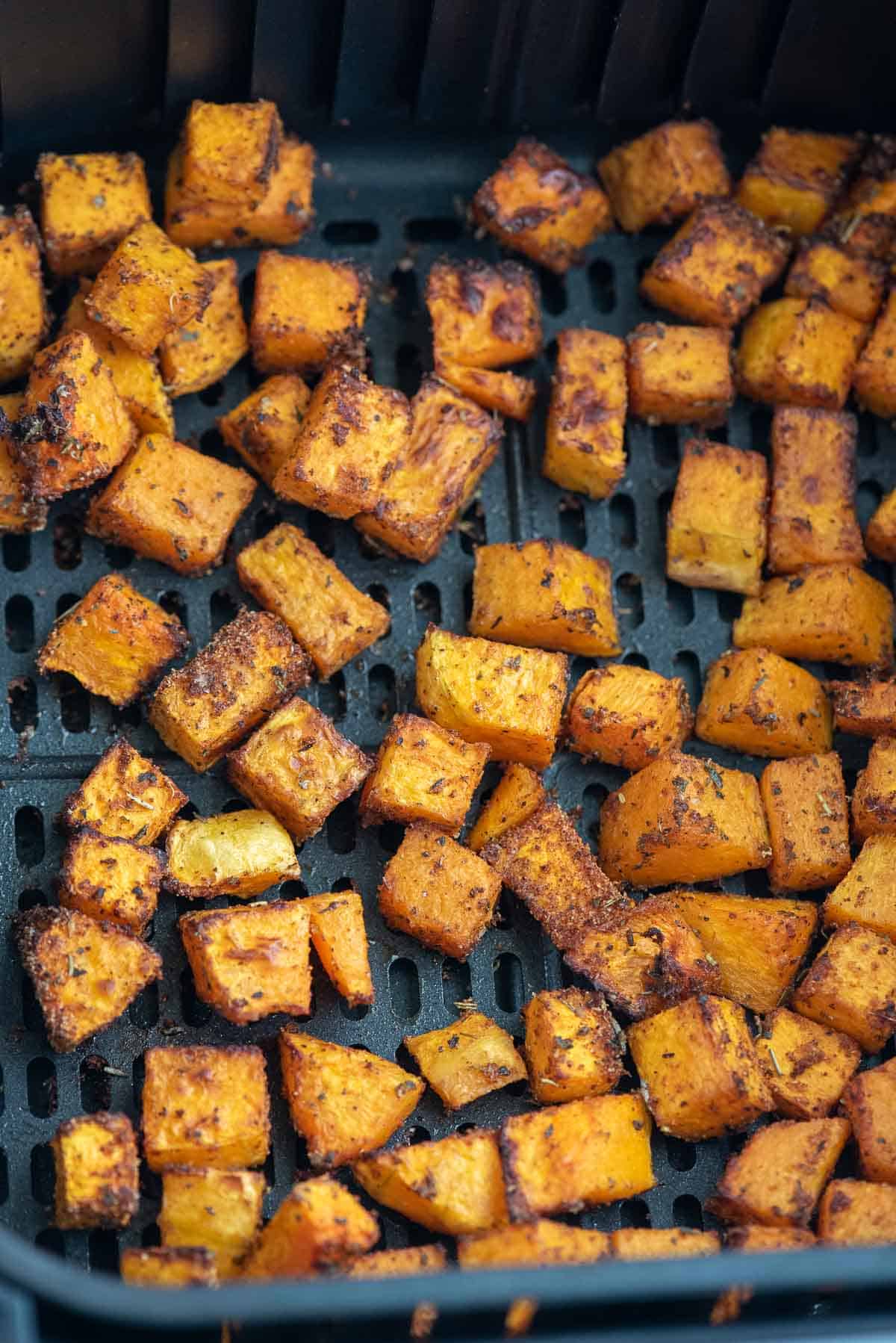 air fryer butternut squash cooked in air fryer basket close up 2.