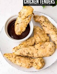 air fryer chicken tenders without breading on a plate with sauce.