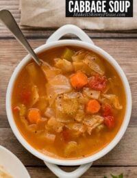 vegetable cabbage soup in a white bowl.